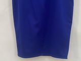 a blue skirt hanging on a white wall