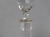 a close up of a clear glass bottle with a silver top