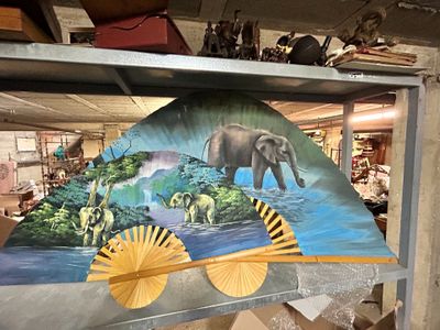 a picture of an elephant and other animals on display
