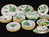 a lot of plates and bowls that are sitting on a table