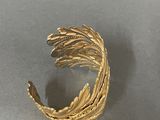 an image of a close up of a gold ring on a table