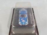 a small blue car in a plastic container on a white surface