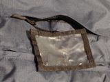 a bag with a zipper on it sitting on a bed