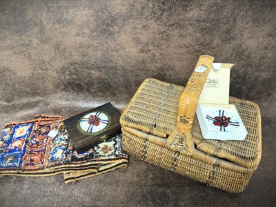 a wicker basket with a clock and a book on it