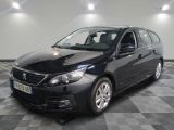 la voiture noire est garée sur un sol en damier dans le garage