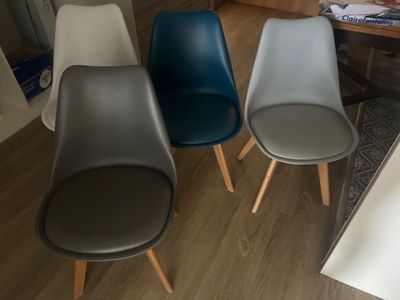 three chairs sitting next to each other on a wooden floor