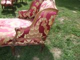 a red and gold couch and chairs in the grass