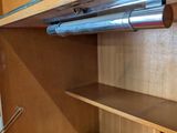 a closet with a shelf and shelves in it