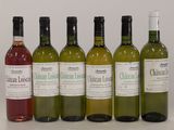 six bottles of wine are lined up in a row on a table