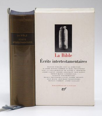 an old book sitting on top of a white table next to a pair of scissors