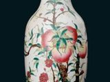 a white vase with a painting of flowers and birds on it