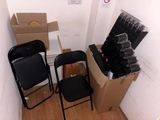 two black chairs and a black chair in a room