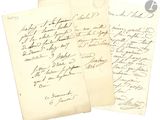 two old letters are sitting on top of a piece of paper