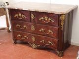 a marble top chest of drawers in the corner of a room