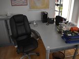 a desk with a chair and a computer on it