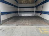 the back of a truck with the door open in a garage