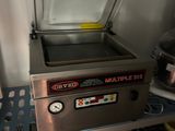 a machine that is sitting on a shelf in a kitchen