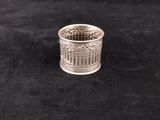a close up of a silver ring on a black surface