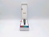 a watch sitting in a box on a white surface