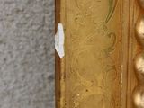 a picture of a gold frame with a picture on it