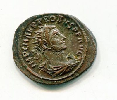 an old coin with a man ' s face on it on a white surface