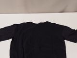 a black shirt sitting on top of a white table