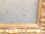 a picture of a gold frame with a picture on it