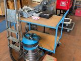 a cart with a lot of tools on it in a warehouse