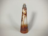a brown and white vase that is on a white table