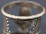 a close up of a silver ring on a table