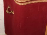 a red chest with gold trim on it in a room