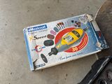 a box that is sitting on the ground next to a skateboard