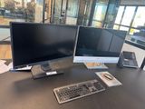 two computer monitors and a keyboard on a desk