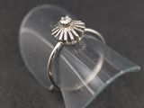 a ring that is sitting on top of a clear glass