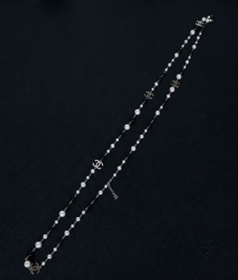 a rosary with a cross and a star on a black background