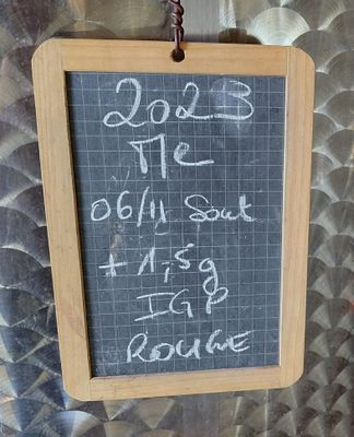 a chalk board with writing on it hanging on a wall