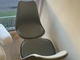 two chairs that are next to each other near a window