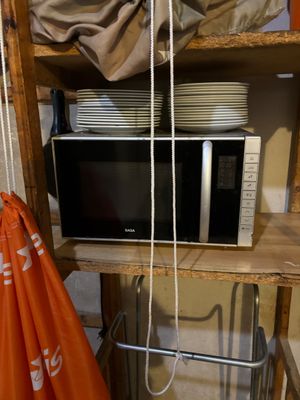 a microwave sitting on top of a shelf in a room