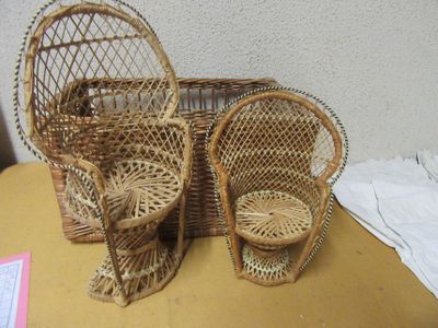 two wicker chairs and a basket on a table