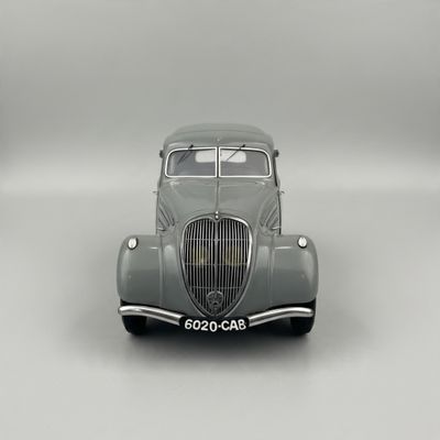 a gray car that is sitting on a white surface
