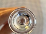 a person holding a glass of water in their hand