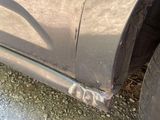 a close up of a car ' s tire on the side of the road