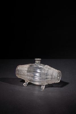 a clear glass container with a lid on a black surface