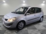 a picture of a small silver car parked in a garage