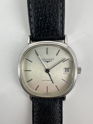 an image of a close up of a wrist watch on a white surface