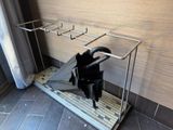 a rack with umbrellas and umbrellas on it in a bathroom
