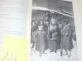 un livre ouvert sur lequel figure l'image d'un groupe de personnes debout devant un train