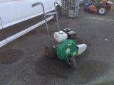 a lawn mower that is sitting on the street