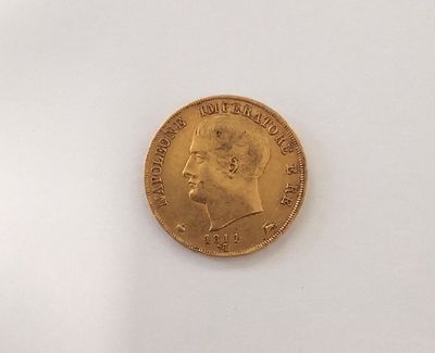 a close up of a gold coin on a white surface