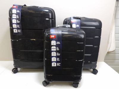 three pieces of luggage that are sitting on a table